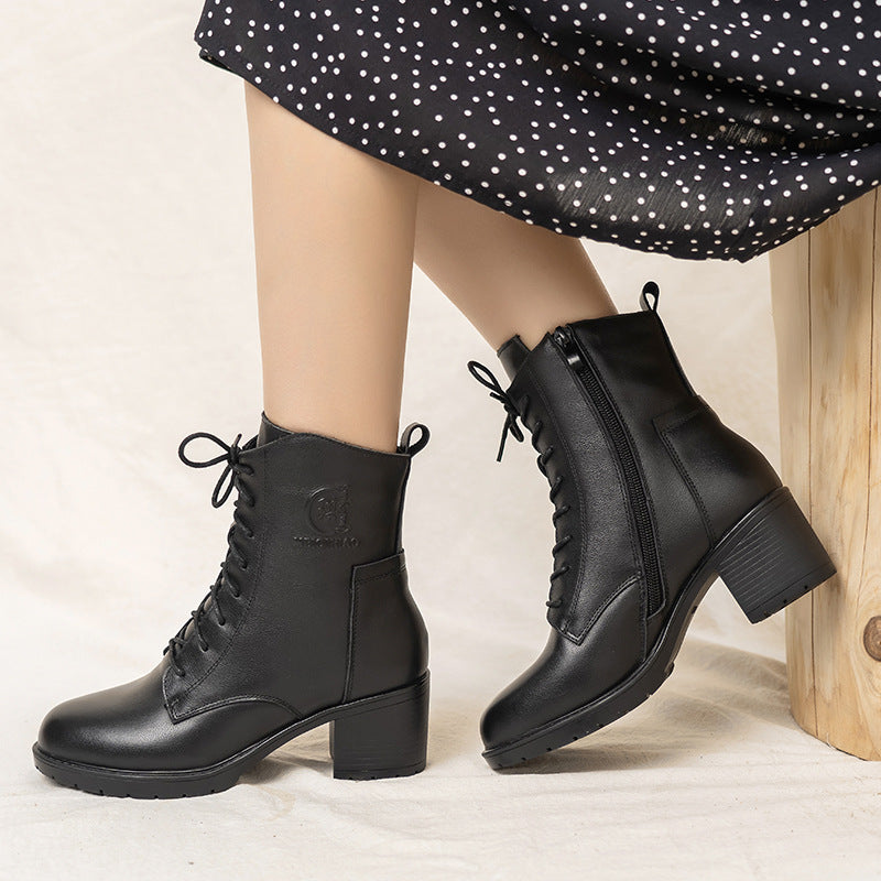 Autumn women's leather chunky heel ankle boots in black with a stylish design, perfect for seasonal wear.