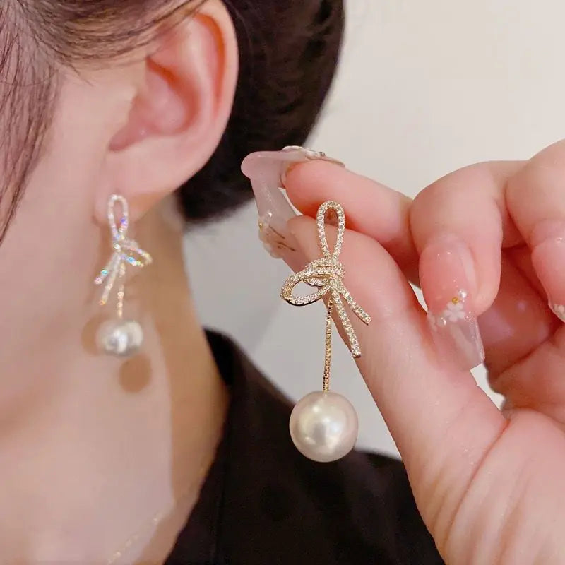 Elegant Bow Pearl Drop Earrings for Women, featuring pearl drops and a versatile design, shown on a white background.